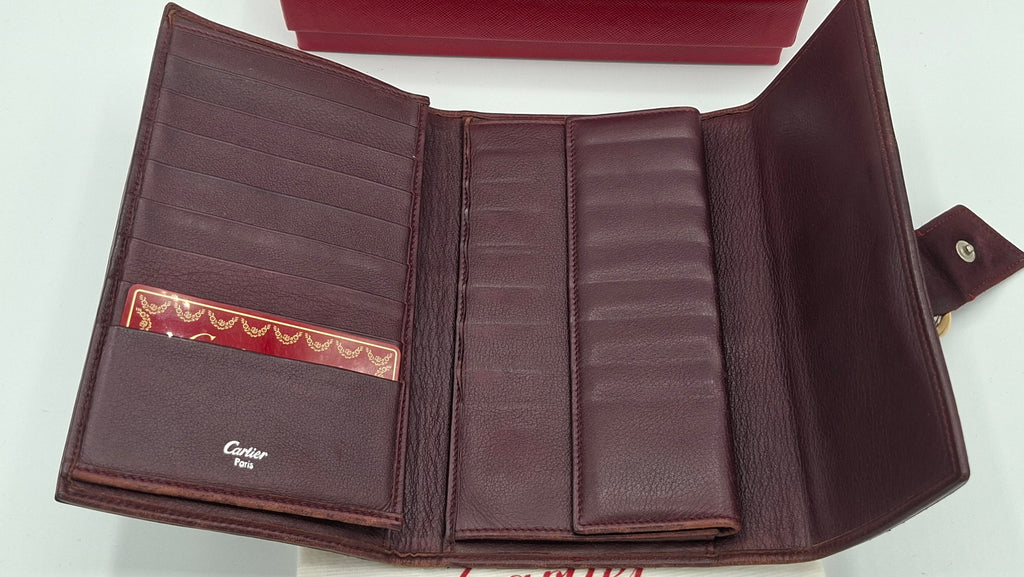 Portefeuille femme Cartier en cuir avec boite et accessoires