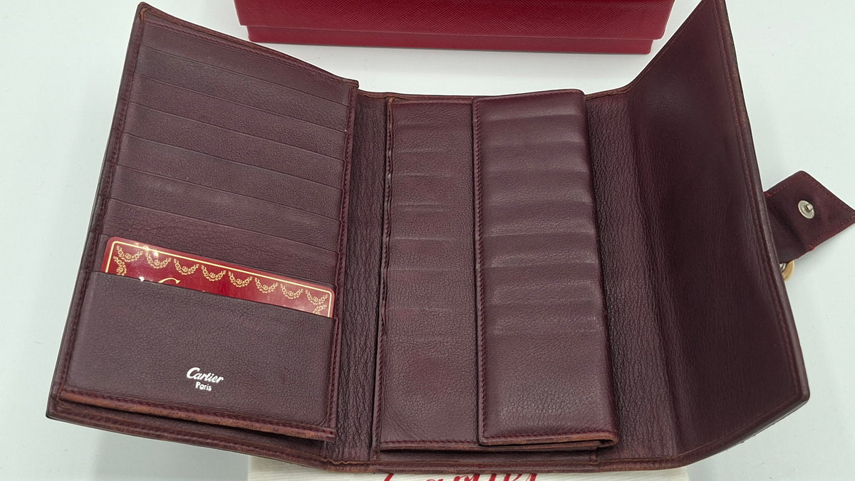 Portefeuille femme Cartier en cuir avec boite et accessoires