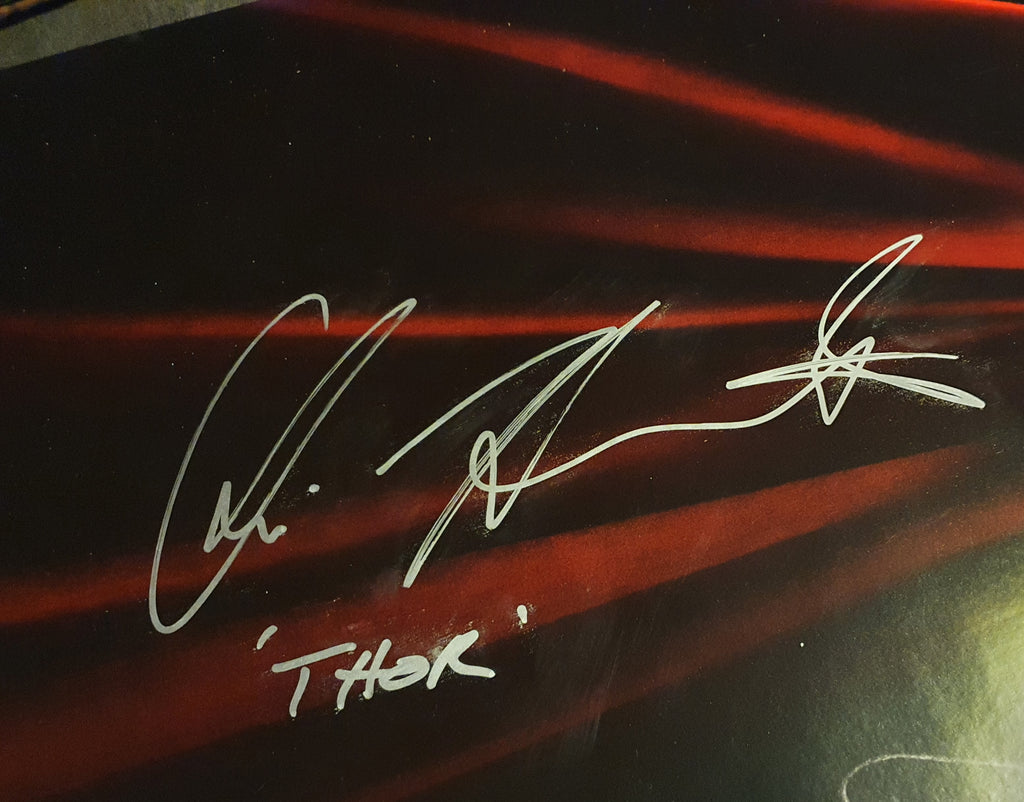 Chris Hemsworth signs Thor movie poster