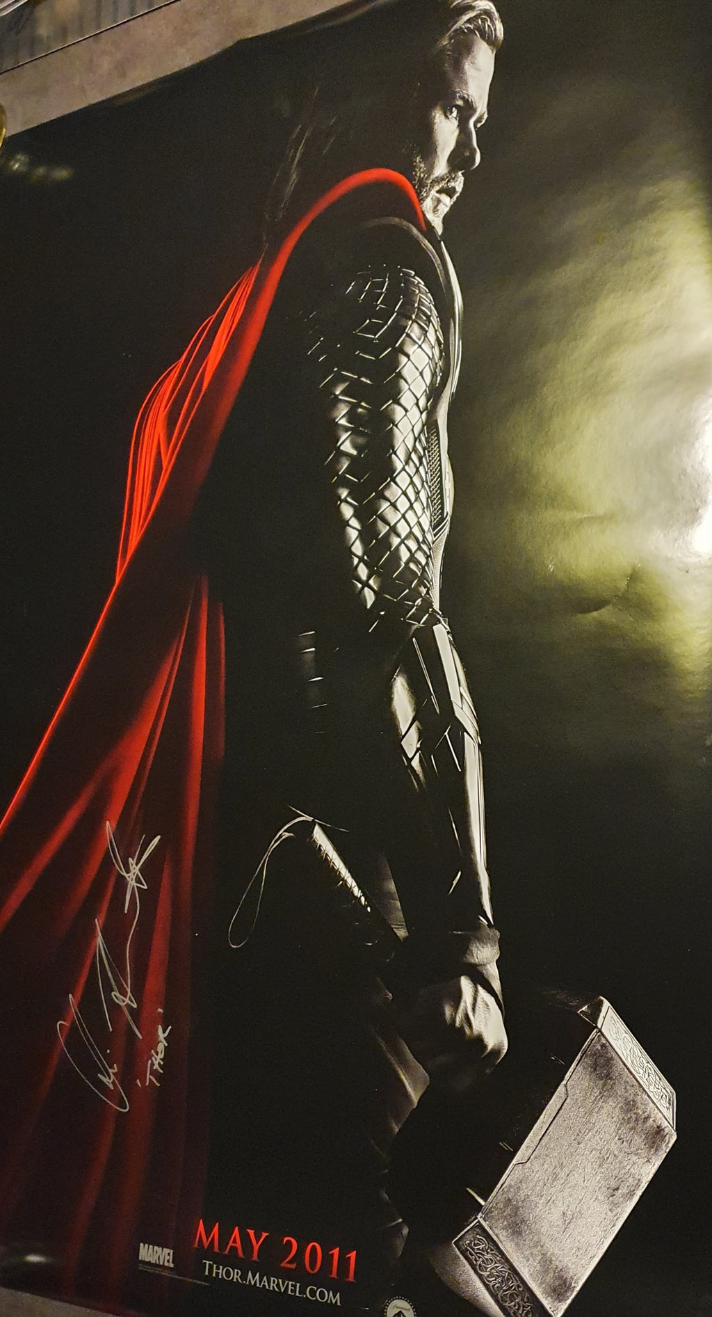 Chris Hemsworth signs Thor movie poster