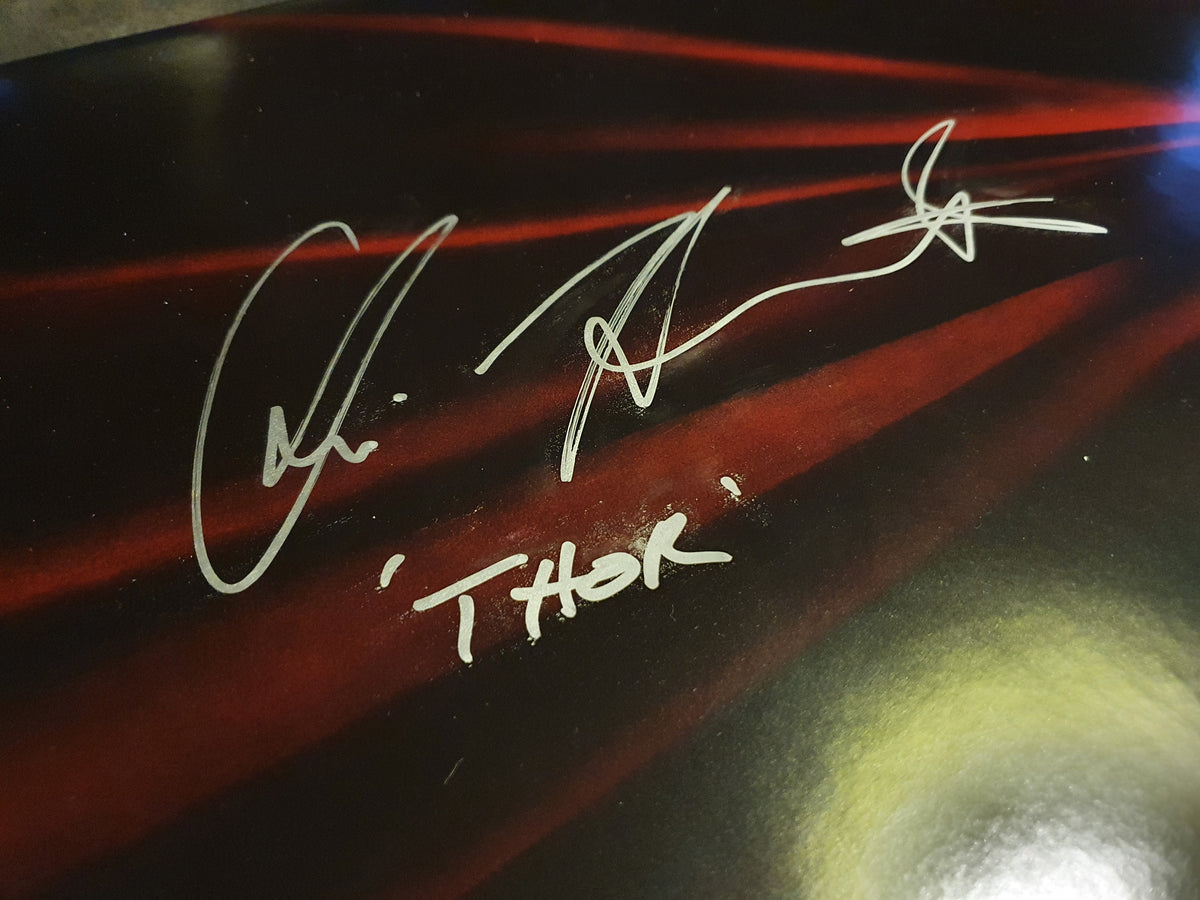 Chris Hemsworth signs Thor movie poster