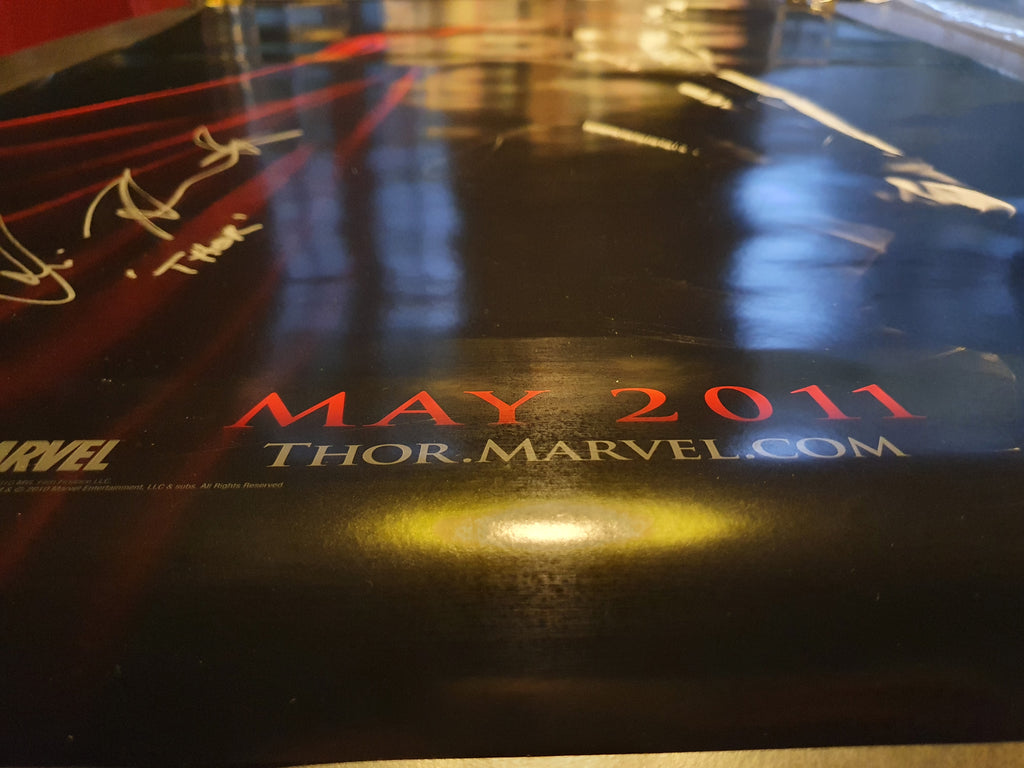 Chris Hemsworth signs Thor movie poster