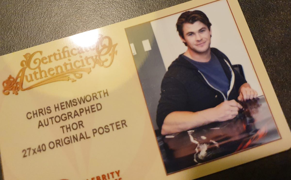 Chris Hemsworth signs Thor movie poster